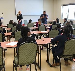 People sit at tables during a shelter event