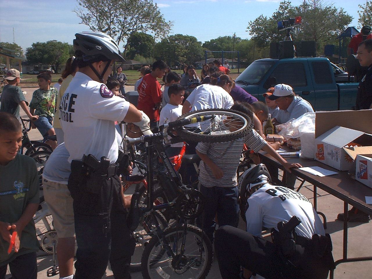 bike patrol fixes bike with citizens