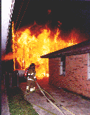 Firefighter protect a house that is in danger